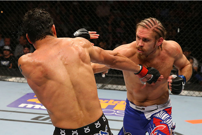 SAN ANTONIO, TX - JUNE 28: (R-L) Andrew Craig punches Cezar Ferreira in their middleweight bout at the AT&T Center on June 28, 2014 in San Antonio, Texas. (Photo by Ed Mulholland/Zuffa LLC/Zuffa LLC via Getty Images)