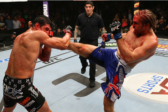 SAN ANTONIO, TX - JUNE 28: (R-L) Andrew Craig kicks Cezar Ferreira in their middleweight bout at the AT&T Center on June 28, 2014 in San Antonio, Texas. (Photo by Ed Mulholland/Zuffa LLC/Zuffa LLC via Getty Images)