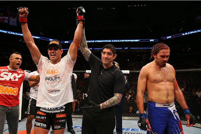 SAN ANTONIO, TX - JUNE 28: Cezar Ferreira (white shirt) reacts to his victory over Andrew Craig (blue shorts) in their middleweight bout at the AT&T Center on June 28, 2014 in San Antonio, Texas. (Photo by Ed Mulholland/Zuffa LLC/Zuffa LLC via Getty Imag
