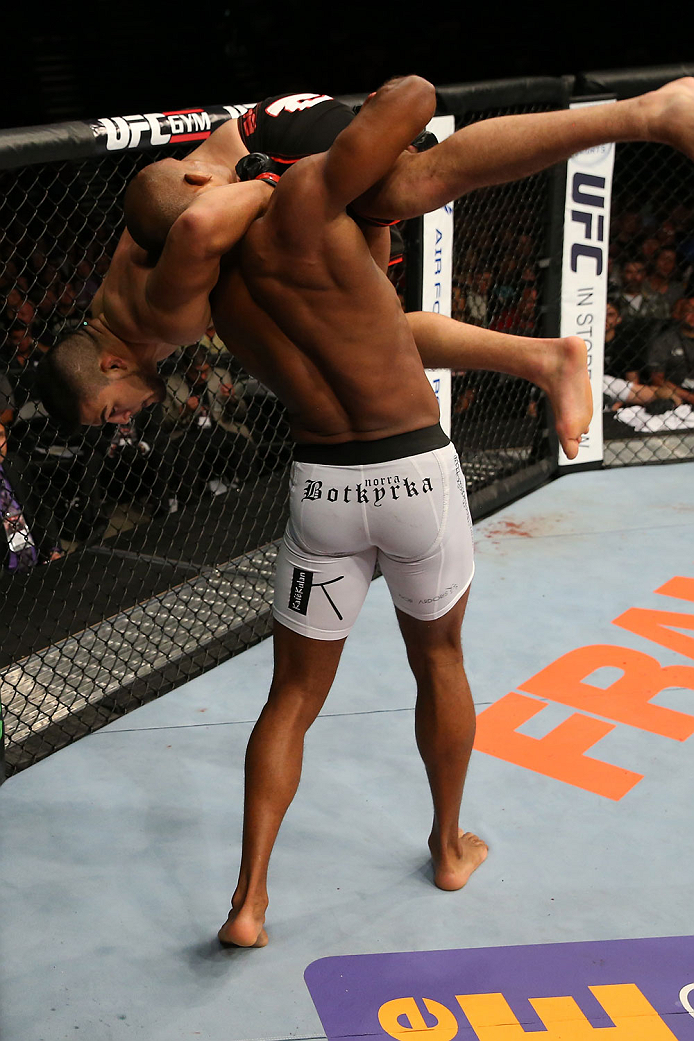 SAN ANTONIO, TX - JUNE 28: Nico Musoke (white shorts) picks up Kelvin Gastelum in their welterweight bout at the AT&T Center on June 28, 2014 in San Antonio, Texas. (Photo by Ed Mulholland/Zuffa LLC/Zuffa LLC via Getty Images)