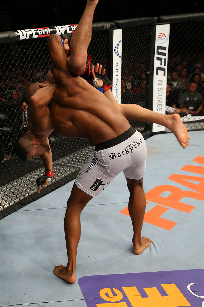 SAN ANTONIO, TX - JUNE 28: Nico Musoke (white shorts) slams Kelvin Gastelum in their welterweight bout at the AT&T Center on June 28, 2014 in San Antonio, Texas. (Photo by Ed Mulholland/Zuffa LLC/Zuffa LLC via Getty Images)