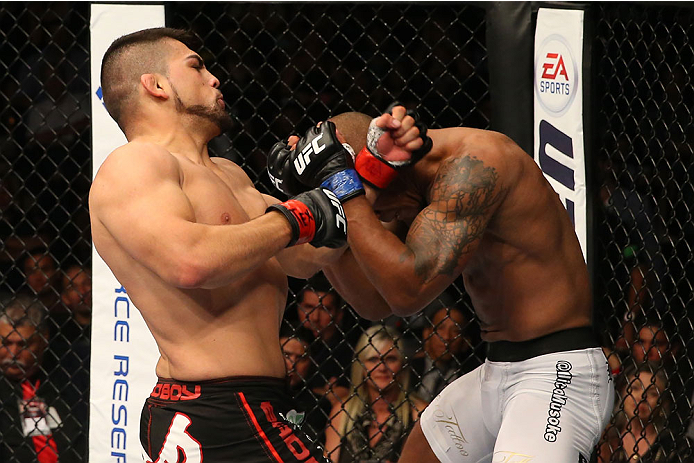 SAN ANTONIO, TX - JUNE 28: (L-R) Kelvin Gastelum punches Nico Musoke in their welterweight bout at the AT&T Center on June 28, 2014 in San Antonio, Texas. (Photo by Ed Mulholland/Zuffa LLC/Zuffa LLC via Getty Images)
