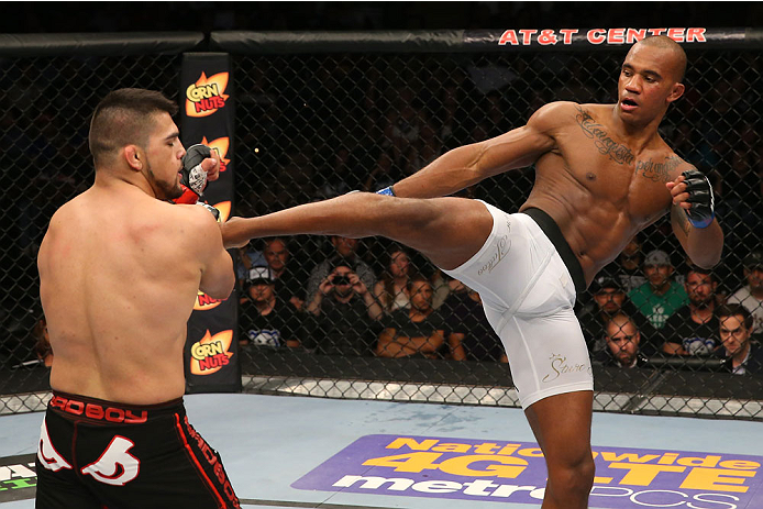 SAN ANTONIO, TX - JUNE 28: (R-L) Nico Musoke kicks Kelvin Gastelum in their welterweight bout at the AT&T Center on June 28, 2014 in San Antonio, Texas. (Photo by Ed Mulholland/Zuffa LLC/Zuffa LLC via Getty Images)