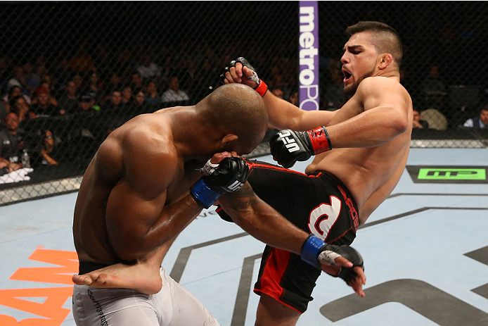 SAN ANTONIO, TX - JUNE 28: (R-L) Kelvin Gastelum kicks Nico Musoke in their welterweight bout at the AT&T Center on June 28, 2014 in San Antonio, Texas. (Photo by Ed Mulholland/Zuffa LLC/Zuffa LLC via Getty Images)
