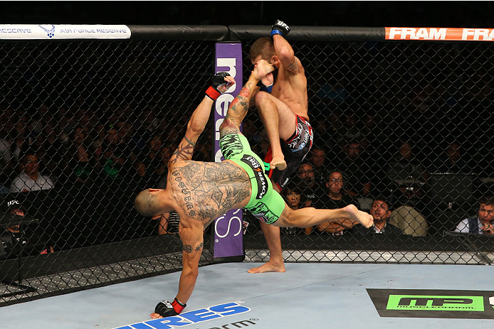 SAN ANTONIO, TX - JUNE 28: Cub Swanson (green shorts) kicks Jeremy Stephens in their featherweight bout at the AT&T Center on June 28, 2014 in San Antonio, Texas. (Photo by Ed Mulholland/Zuffa LLC/Zuffa LLC via Getty Images)