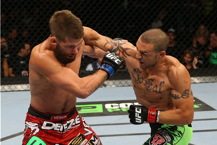 SAN ANTONIO, TX - JUNE 28: (R-L) Cub Swanson punches Jeremy Stephens in their featherweight bout at the AT&T Center on June 28, 2014 in San Antonio, Texas. (Photo by Ed Mulholland/Zuffa LLC/Zuffa LLC via Getty Images)