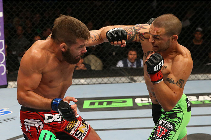 SAN ANTONIO, TX - JUNE 28: (R-L) Cub Swanson punches Jeremy Stephens in their featherweight bout at the AT&T Center on June 28, 2014 in San Antonio, Texas. (Photo by Ed Mulholland/Zuffa LLC/Zuffa LLC via Getty Images)