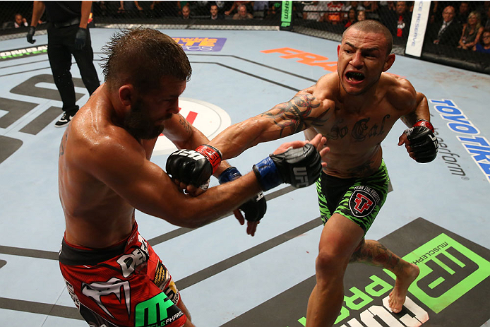 SAN ANTONIO, TX - JUNE 28: (R-L) Cub Swanson punches Jeremy Stephens in their featherweight bout at the AT&T Center on June 28, 2014 in San Antonio, Texas. (Photo by Ed Mulholland/Zuffa LLC/Zuffa LLC via Getty Images)