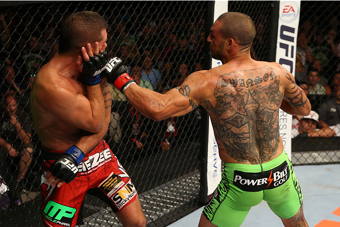 SAN ANTONIO, TX - JUNE 28: (R-L) Cub Swanson punches Jeremy Stephens in their featherweight bout at the AT&T Center on June 28, 2014 in San Antonio, Texas. (Photo by Ed Mulholland/Zuffa LLC/Zuffa LLC via Getty Images)