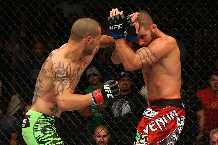 SAN ANTONIO, TX - JUNE 28: (L-R) Cub Swanson punches Jeremy Stephens in their featherweight bout at the AT&T Center on June 28, 2014 in San Antonio, Texas. (Photo by Ed Mulholland/Zuffa LLC/Zuffa LLC via Getty Images)