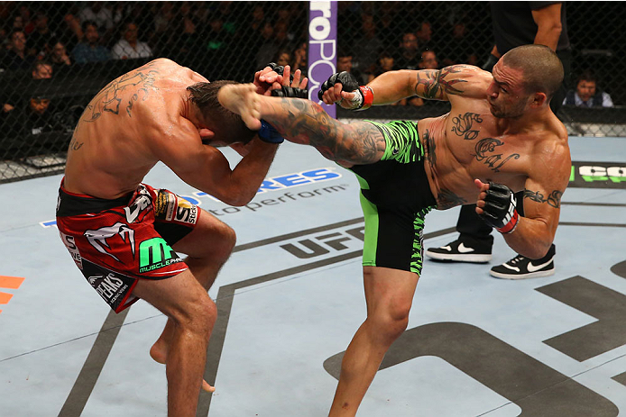 SAN ANTONIO, TX - JUNE 28: (R-L) Cub Swanson kicks Jeremy Stephens in their featherweight bout at the AT&T Center on June 28, 2014 in San Antonio, Texas. (Photo by Ed Mulholland/Zuffa LLC/Zuffa LLC via Getty Images)