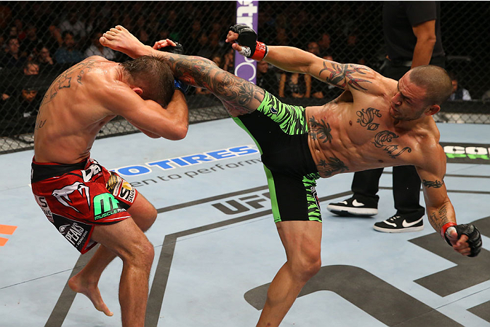 SAN ANTONIO, TX - JUNE 28: (R-L) Cub Swanson kicks Jeremy Stephens in their featherweight bout at the AT&T Center on June 28, 2014 in San Antonio, Texas. (Photo by Ed Mulholland/Zuffa LLC/Zuffa LLC via Getty Images)