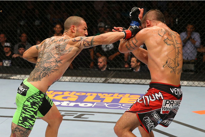 SAN ANTONIO, TX - JUNE 28: (L-R) Cub Swanson punches Jeremy Stephens in their featherweight bout at the AT&T Center on June 28, 2014 in San Antonio, Texas. (Photo by Ed Mulholland/Zuffa LLC/Zuffa LLC via Getty Images)