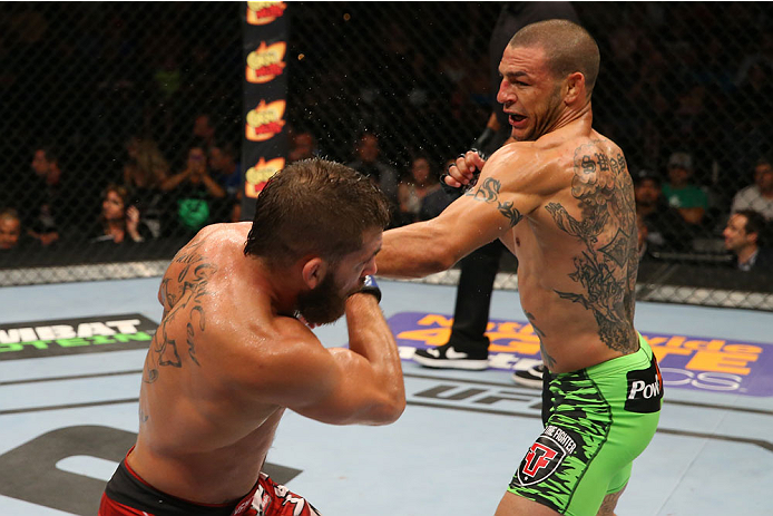 SAN ANTONIO, TX - JUNE 28: (R-L) Cub Swanson punches Jeremy Stephens in their featherweight bout at the AT&T Center on June 28, 2014 in San Antonio, Texas. (Photo by Ed Mulholland/Zuffa LLC/Zuffa LLC via Getty Images)