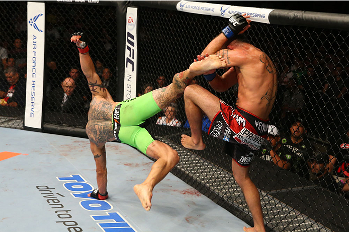 SAN ANTONIO, TX - JUNE 28: (L-R) Cub Swanson kicks Jeremy Stephens in their featherweight bout at the AT&T Center on June 28, 2014 in San Antonio, Texas. (Photo by Ed Mulholland/Zuffa LLC/Zuffa LLC via Getty Images)