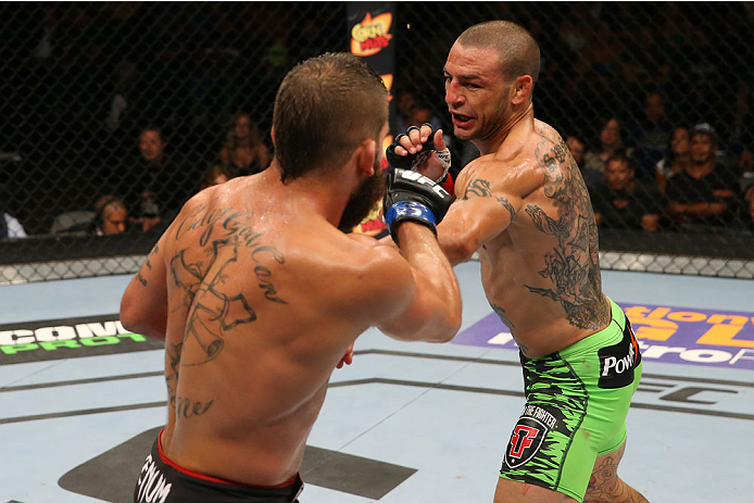 SAN ANTONIO, TX - JUNE 28: (R-L) Cub Swanson punches Jeremy Stephens in their featherweight bout at the AT&T Center on June 28, 2014 in San Antonio, Texas. (Photo by Ed Mulholland/Zuffa LLC/Zuffa LLC via Getty Images)