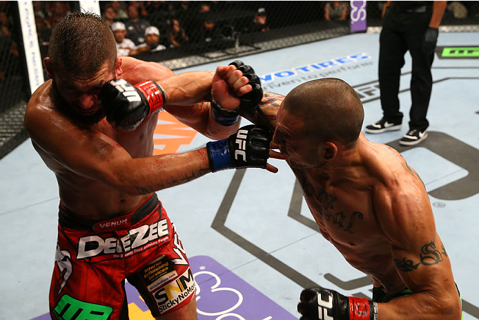 SAN ANTONIO, TX - JUNE 28: (R-L) Cub Swanson punches Jeremy Stephens in their featherweight bout at the AT&T Center on June 28, 2014 in San Antonio, Texas. (Photo by Ed Mulholland/Zuffa LLC/Zuffa LLC via Getty Images)