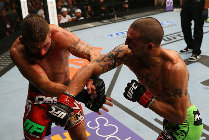 SAN ANTONIO, TX - JUNE 28: (R-L) Cub Swanson punches Jeremy Stephens in their featherweight bout at the AT&T Center on June 28, 2014 in San Antonio, Texas. (Photo by Ed Mulholland/Zuffa LLC/Zuffa LLC via Getty Images)