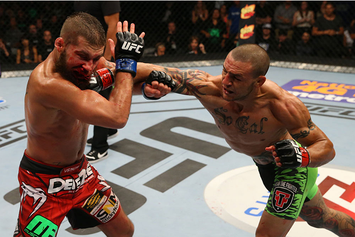 SAN ANTONIO, TX - JUNE 28: (R-L) Cub Swanson punches Jeremy Stephens in their featherweight bout at the AT&T Center on June 28, 2014 in San Antonio, Texas. (Photo by Ed Mulholland/Zuffa LLC/Zuffa LLC via Getty Images)