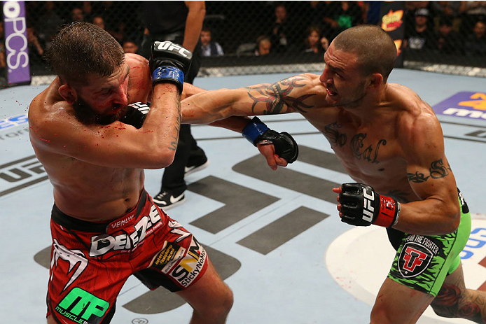 SAN ANTONIO, TX - JUNE 28: (R-L) Cub Swanson punches Jeremy Stephens in their featherweight bout at the AT&T Center on June 28, 2014 in San Antonio, Texas. (Photo by Ed Mulholland/Zuffa LLC/Zuffa LLC via Getty Images)