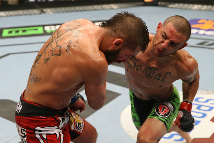 SAN ANTONIO, TX - JUNE 28: (R-L) Cub Swanson punches Jeremy Stephens in their featherweight bout at the AT&T Center on June 28, 2014 in San Antonio, Texas. (Photo by Ed Mulholland/Zuffa LLC/Zuffa LLC via Getty Images)