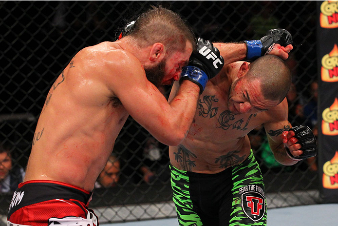 SAN ANTONIO, TX - JUNE 28: (R-L) Cub Swanson punches Jeremy Stephens in their featherweight bout at the AT&T Center on June 28, 2014 in San Antonio, Texas. (Photo by Ed Mulholland/Zuffa LLC/Zuffa LLC via Getty Images)