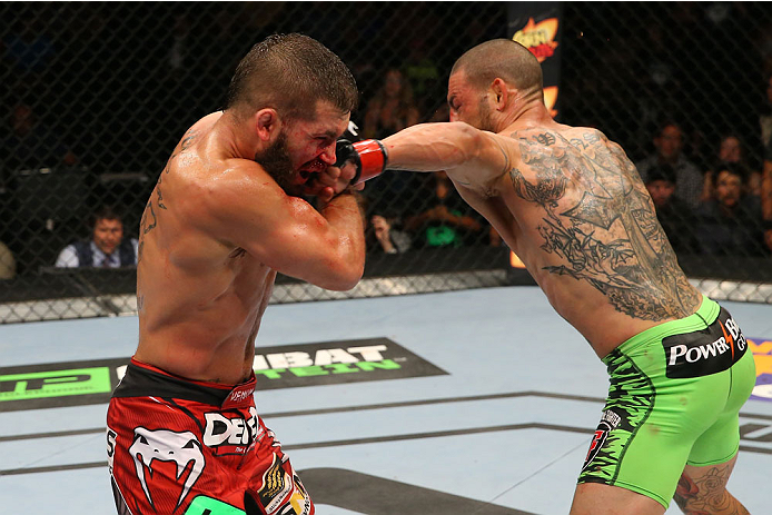 SAN ANTONIO, TX - JUNE 28: (R-L) Cub Swanson punches Jeremy Stephens in their featherweight bout at the AT&T Center on June 28, 2014 in San Antonio, Texas. (Photo by Ed Mulholland/Zuffa LLC/Zuffa LLC via Getty Images)