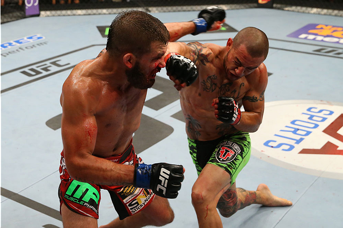 SAN ANTONIO, TX - JUNE 28: (R-L) Cub Swanson punches Jeremy Stephens in their featherweight bout at the AT&T Center on June 28, 2014 in San Antonio, Texas. (Photo by Ed Mulholland/Zuffa LLC/Zuffa LLC via Getty Images)