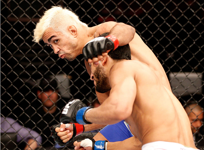 NATAL, BRAZIL - MARCH 23: (L-R) Godofredo "Pepey" Castro punches Noad Lahat in their featherweight bout during the UFC Fight Night event at Ginasio Nelio Dias on March 23, 2014 in Natal, Brazil. (Photo by Josh Hedges/Zuffa LLC/Zuffa LLC via Getty Images)