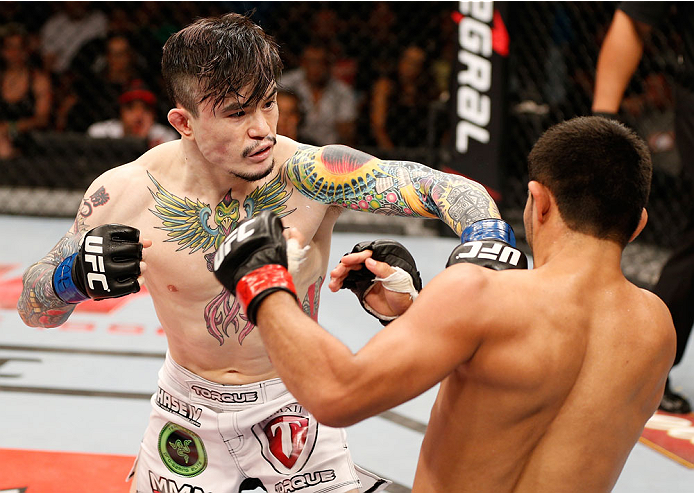 NATAL, BRAZIL - MARCH 23: (L-R) Scott Jorgensen punches Jussier Formiga in their flyweight bout during the UFC Fight Night event at Ginasio Nelio Dias on March 23, 2014 in Natal, Brazil. (Photo by Josh Hedges/Zuffa LLC/Zuffa LLC via Getty Images)