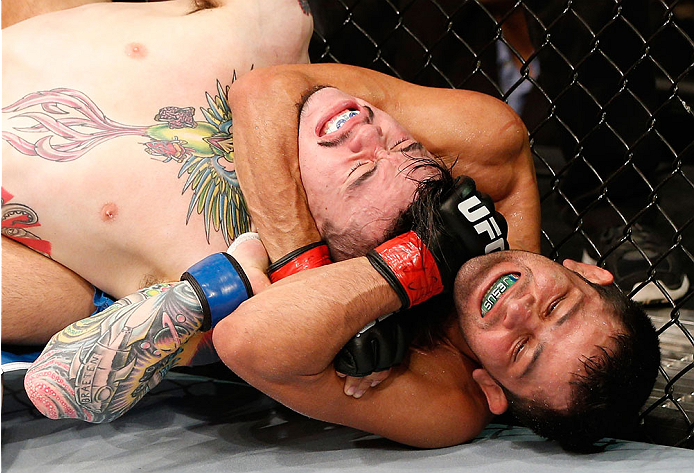 NATAL, BRAZIL - MARCH 23: (R-L) Jussier Formiga secures a rear choke submission against Scott Jorgensen in their flyweight bout during the UFC Fight Night event at Ginasio Nelio Dias on March 23, 2014 in Natal, Brazil. (Photo by Josh Hedges/Zuffa LLC/Zuf