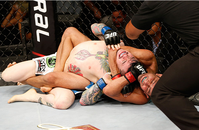 NATAL, BRAZIL - MARCH 23: (R-L) Jussier Formiga secures a rear choke submission against Scott Jorgensen in their flyweight bout during the UFC Fight Night event at Ginasio Nelio Dias on March 23, 2014 in Natal, Brazil. (Photo by Josh Hedges/Zuffa LLC/Zuf