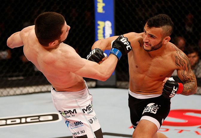 JARAGUA DO SUL, BRAZIL - MAY 18: (R-L) John Lineker punches Azamat Gashimov in their flyweight bout during the UFC on FX event on May 18, 2013 at Arena Jaragua in Jaragua do Sul, Santa Catarina, Brazil. (Photo by Josh Hedges/Zuffa LLC/Zuffa LLC via Get