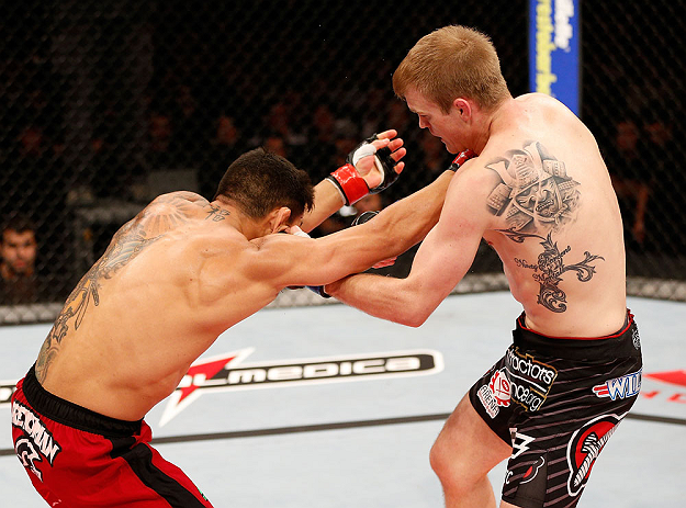 JARAGUA DO SUL, BRAZIL - MAY 18: (R-L) Evan Dunham punches Rafael dos Anjos in their lightweight bout during the UFC on FX event on May 18, 2013 at Arena Jaragua in Jaragua do Sul, Santa Catarina, Brazil. (Photo by Josh Hedges/Zuffa LLC/Zuffa LLC via Gett