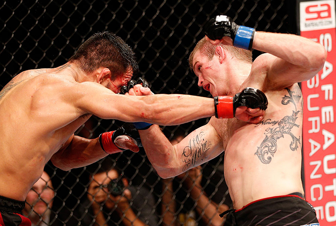 JARAGUA DO SUL, BRAZIL - MAY 18: (R-L) Evan Dunham punches Rafael dos Anjos in their lightweight bout during the UFC on FX event on May 18, 2013 at Arena Jaragua in Jaragua do Sul, Santa Catarina, Brazil. (Photo by Josh Hedges/Zuffa LLC/Zuffa LLC via G