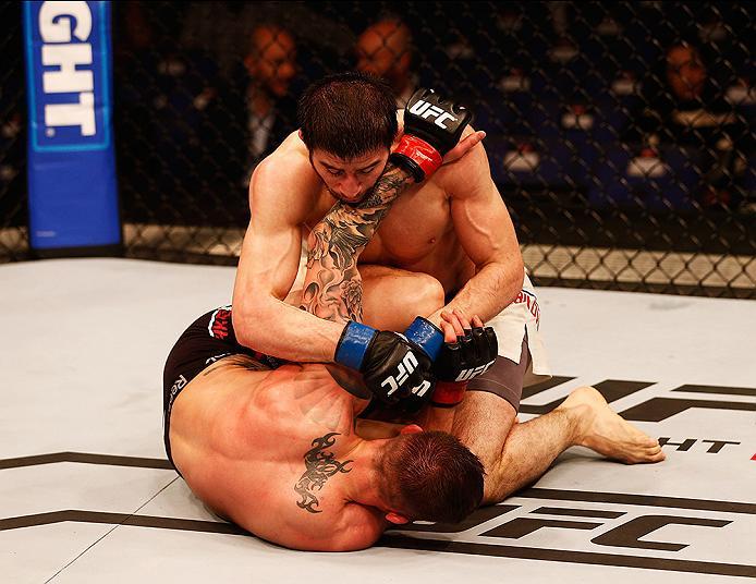 LONDON, ENGLAND - FEBRUARY 27: Norman 'Stormin' Parke of Northern Ireland is taken down to the floor by Rustam 'Tiger' Khabilov of Russia compete in their Lightweight bout during the UFC Fight Night held at at Indigo at The O2 Arena on February 27, 2016