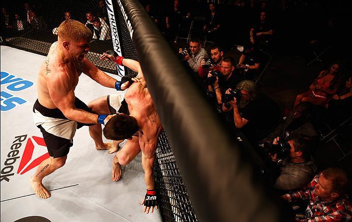 LONDON, ENGLAND - FEBRUARY 27: Photographers get their shots as Scott Askham of England (R) and Chris Dempsey of the USA (L) compete in their Middleweight bout during the UFC Fight Night held at at Indigo at The O2 Arena on February 27, 2016 in London, En