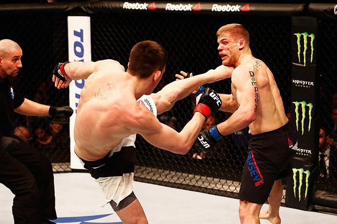 LONDON, ENGLAND - FEBRUARY 27: Scott Askham of England (L) KO's Chris Dempsey of the USA with a high kick in their Middleweight bout during the UFC Fight Night held at at Indigo at The O2 Arena on February 27, 2016 in London, England. (Photo by Dean Mou