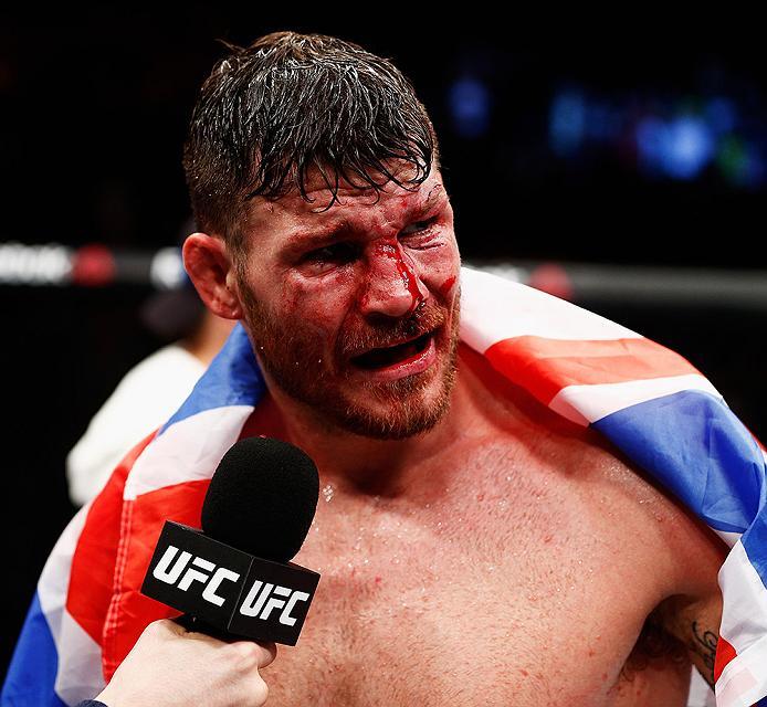 LONDON, ENGLAND - FEBRUARY 27: A bloody and battered Michael 'The Count' Bisping of England celebrates victory over Anderson 'The Spider' Silva of Brazil in their Middleweight bout during the UFC Fight Night held at at Indigo at The O2 Arena on February