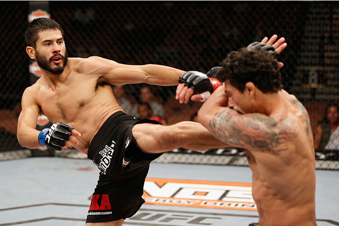 LAS VEGAS, NV - JULY 06: (L-R) Juan Maneul Puig Carreon kicks Adriano Martins in their lightweight fight during the Ultimate Fighter Finale inside the Mandalay Bay Events Center on July 6, 2014 in Las Vegas, Nevada. (Photo by Josh Hedges/Zuffa LLC/Zuffa