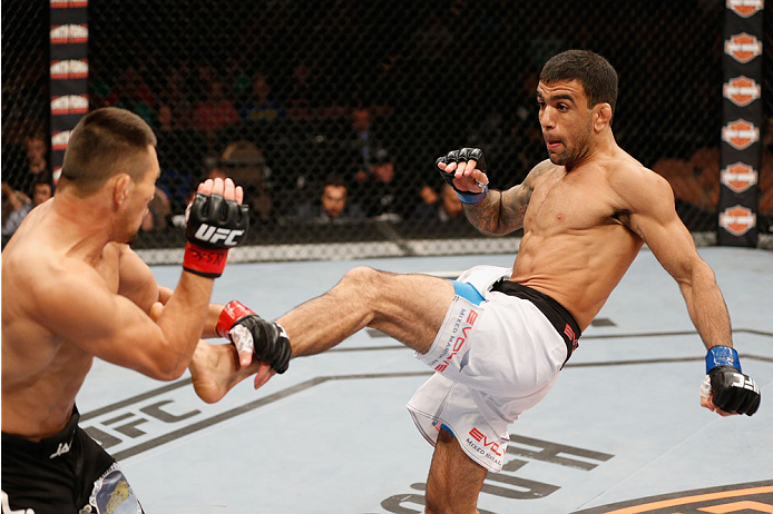 LAS VEGAS, NV - JULY 06: (R-L) Leandro Issa kicks Jumabieke Tuerxun in their bantamweight fight during the Ultimate Fighter Finale inside the Mandalay Bay Events Center on July 6, 2014 in Las Vegas, Nevada. (Photo by Josh Hedges/Zuffa LLC/Zuffa LLC via