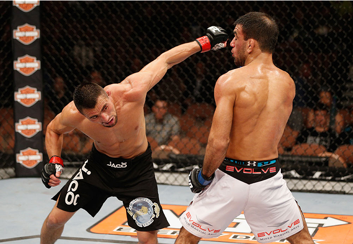 LAS VEGAS, NV - JULY 06: (L-R) Jumabieke Tuerxun punches Leandro Issa in their bantamweight fight during the Ultimate Fighter Finale inside the Mandalay Bay Events Center on July 6, 2014 in Las Vegas, Nevada. (Photo by Josh Hedges/Zuffa LLC/Zuffa LLC vi