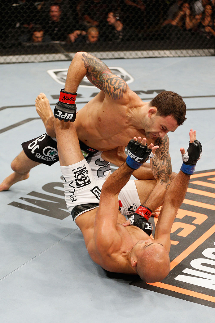LAS VEGAS, NV - JULY 06: Frankie Edgar (top) punches BJ Penn in their featherweight fight during the Ultimate Fighter Finale inside the Mandalay Bay Events Center on July 6, 2014 in Las Vegas, Nevada. (Photo by Josh Hedges/Zuffa LLC/Zuffa LLC via Getty