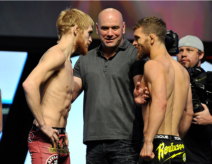 LAS VEGAS, NV - JULY 05: UFC president Dana White (C) seperates mixed martial artists Justin Scoggins (L) and Dustin Ortiz during their face off at the TUF 19 Finale weigh-in at the Mandalay Bay Convention Center on July 5, 2014 in Las Vegas, Nevada. (P