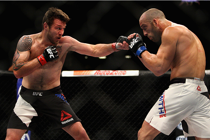 LAS VEGAS, NV - JULY 12: (L-R) Dan Miller punches Trevor Smith in their middleweight bout during the Ultimate Fighter Finale inside MGM Grand Garden Arena on July 12, 2015 in Las Vegas, Nevada. (Photo by Mitch Viquez/Zuffa LLC/Zuffa LLC via Getty Images