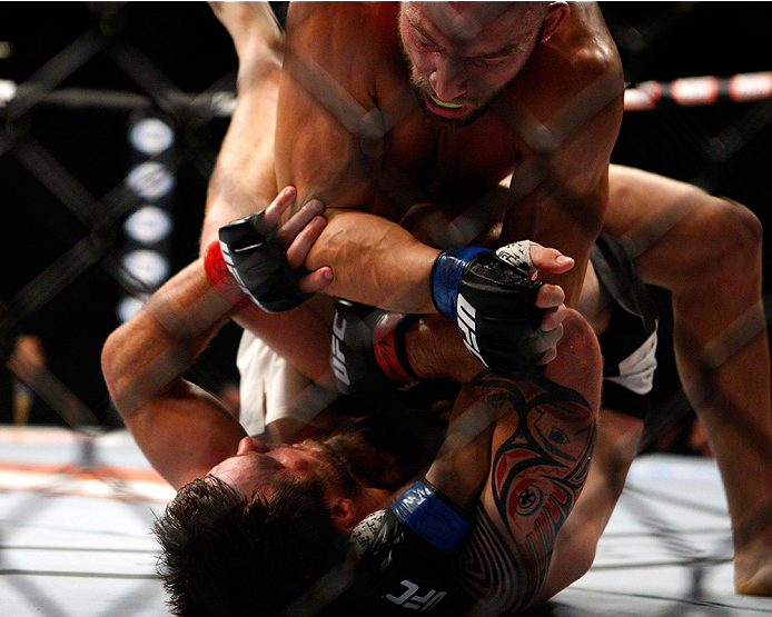 LAS VEGAS, NV - JULY 12: Trevor Smith (top) punches Dan Miller in their middleweight bout during the Ultimate Fighter Finale inside MGM Grand Garden Arena on July 12, 2015 in Las Vegas, Nevada. (Photo by Mitch Viquez/Zuffa LLC/Zuffa LLC via Getty Images
