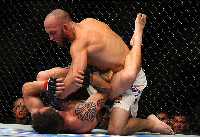 LAS VEGAS, NV - JULY 12: Trevor Smith (top) punches Dan Miller in their middleweight bout during the Ultimate Fighter Finale inside MGM Grand Garden Arena on July 12, 2015 in Las Vegas, Nevada. (Photo by Mitch Viquez/Zuffa LLC/Zuffa LLC via Getty Images
