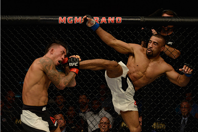 LAS VEGAS, NV - JULY 12: (R-L) Jerrod Sanders kicks Russell Doane in their bantamweight bout during the Ultimate Fighter Finale inside MGM Grand Garden Arena on July 12, 2015 in Las Vegas, Nevada. (Photo by Brandon Magnus/Zuffa LLC/Zuffa LLC via Getty I