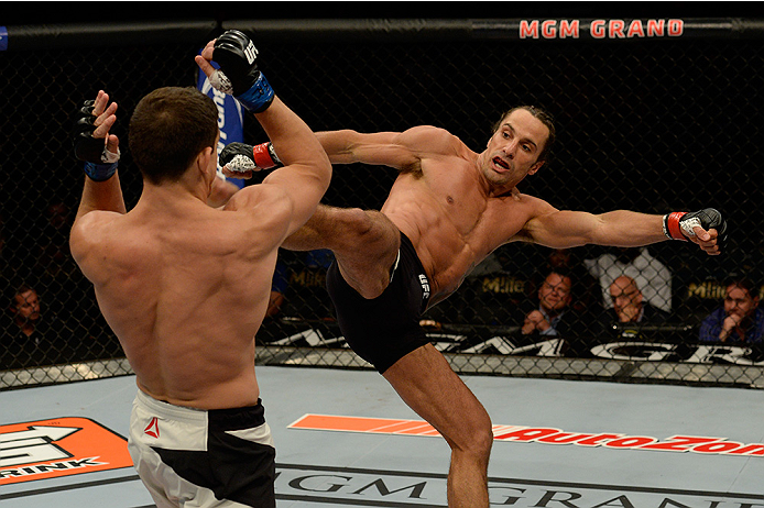 LAS VEGAS, NV - JULY 12: (R-L) Josh Samman kicks Caio Magalhaes in their middleweight bout during the Ultimate Fighter Finale inside MGM Grand Garden Arena on July 12, 2015 in Las Vegas, Nevada. (Photo by Brandon Magnus/Zuffa LLC/Zuffa LLC via Getty Ima