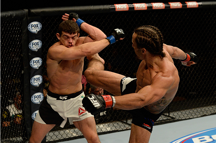 LAS VEGAS, NV - JULY 12: (R-L) Josh Samman kicks Caio Magalhaes in their middleweight bout during the Ultimate Fighter Finale inside MGM Grand Garden Arena on July 12, 2015 in Las Vegas, Nevada. (Photo by Brandon Magnus/Zuffa LLC/Zuffa LLC via Getty Ima